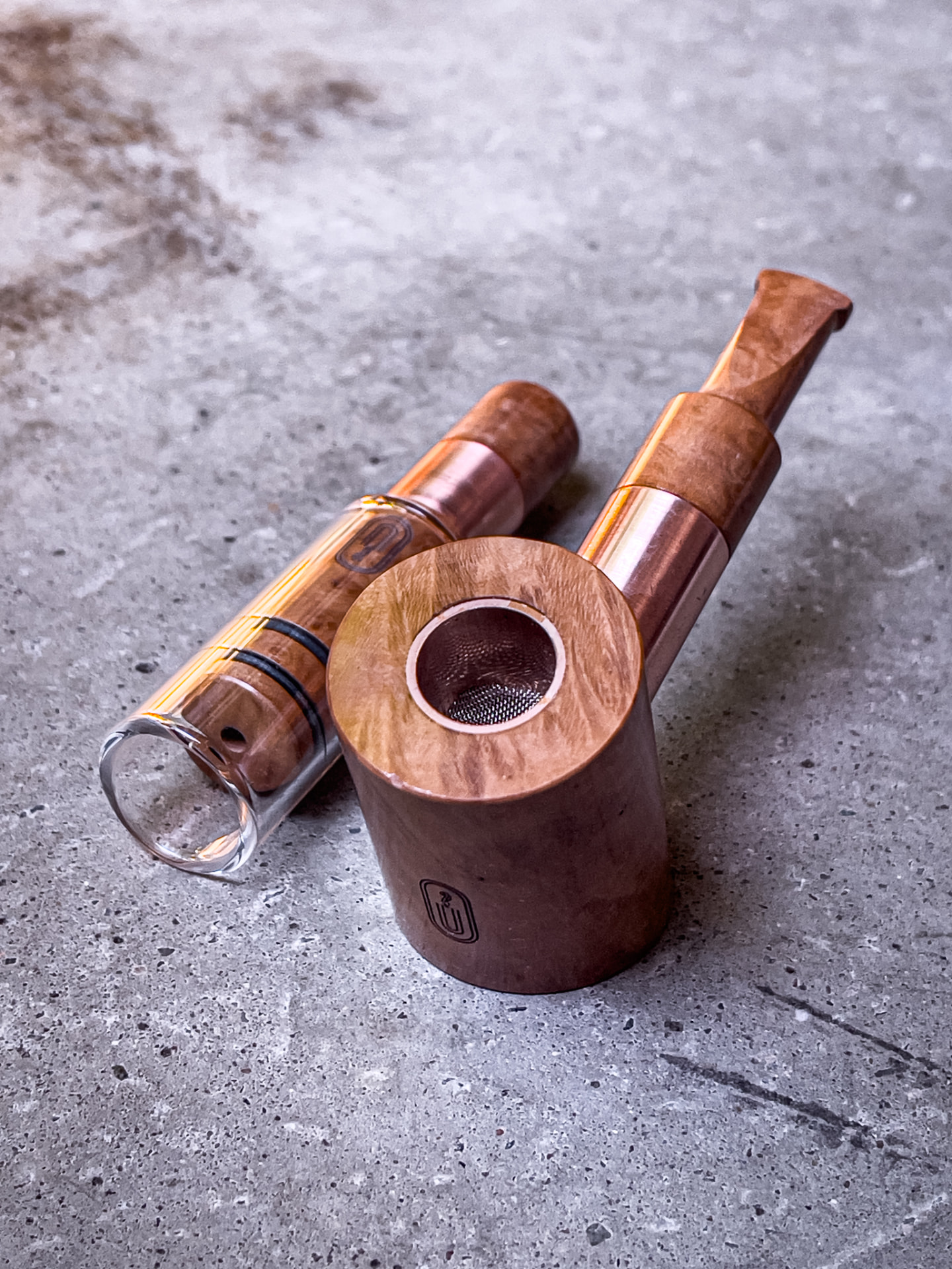 Custom briar and copper Poker Pipe and Sir Winston's Cigar on a stone surface