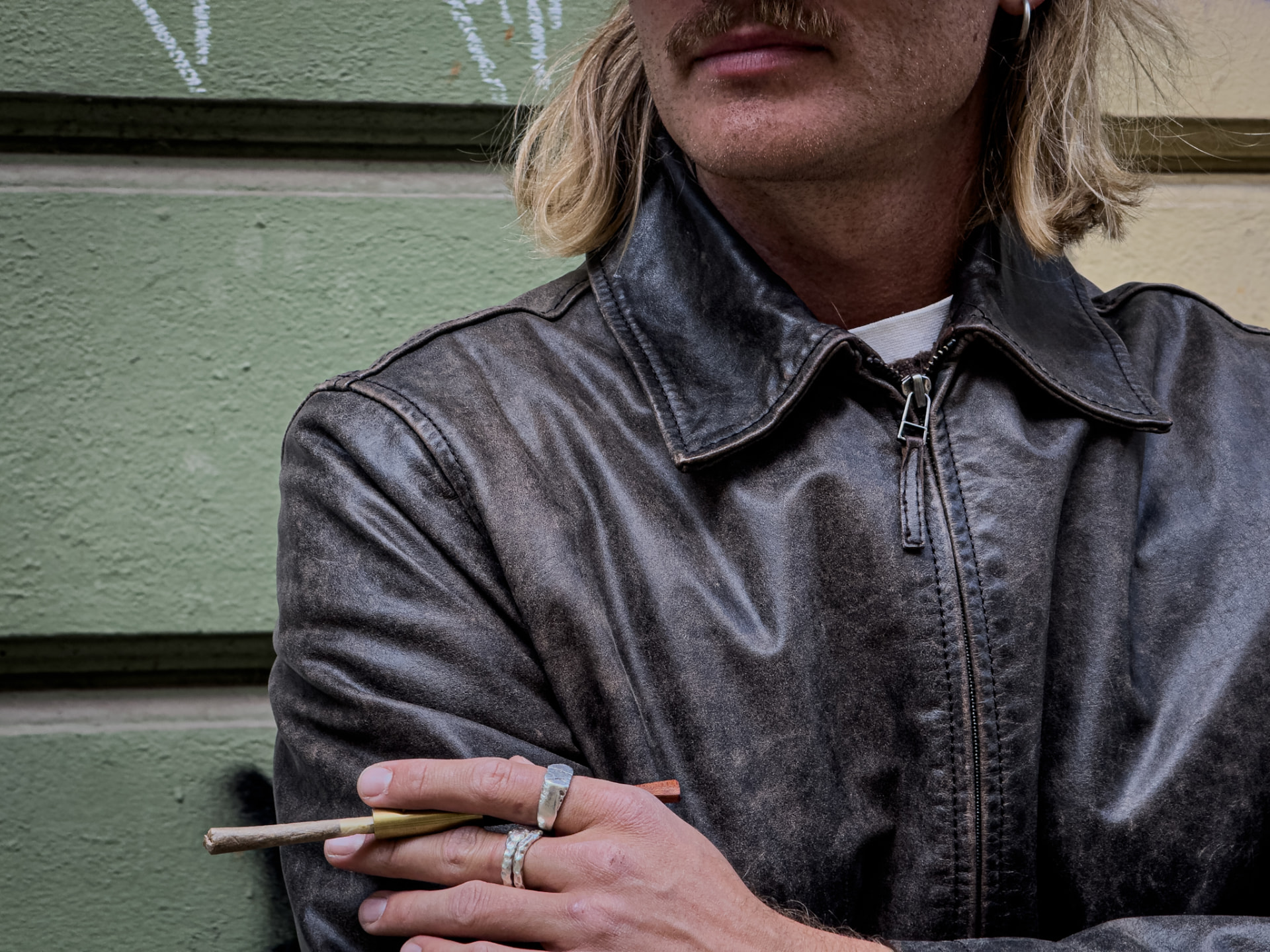 Hand holding a wooden cigarette holder