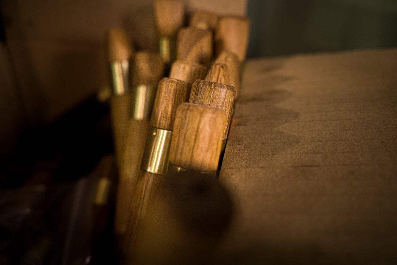 A small batch of finished wooden pieces with brass ferrules