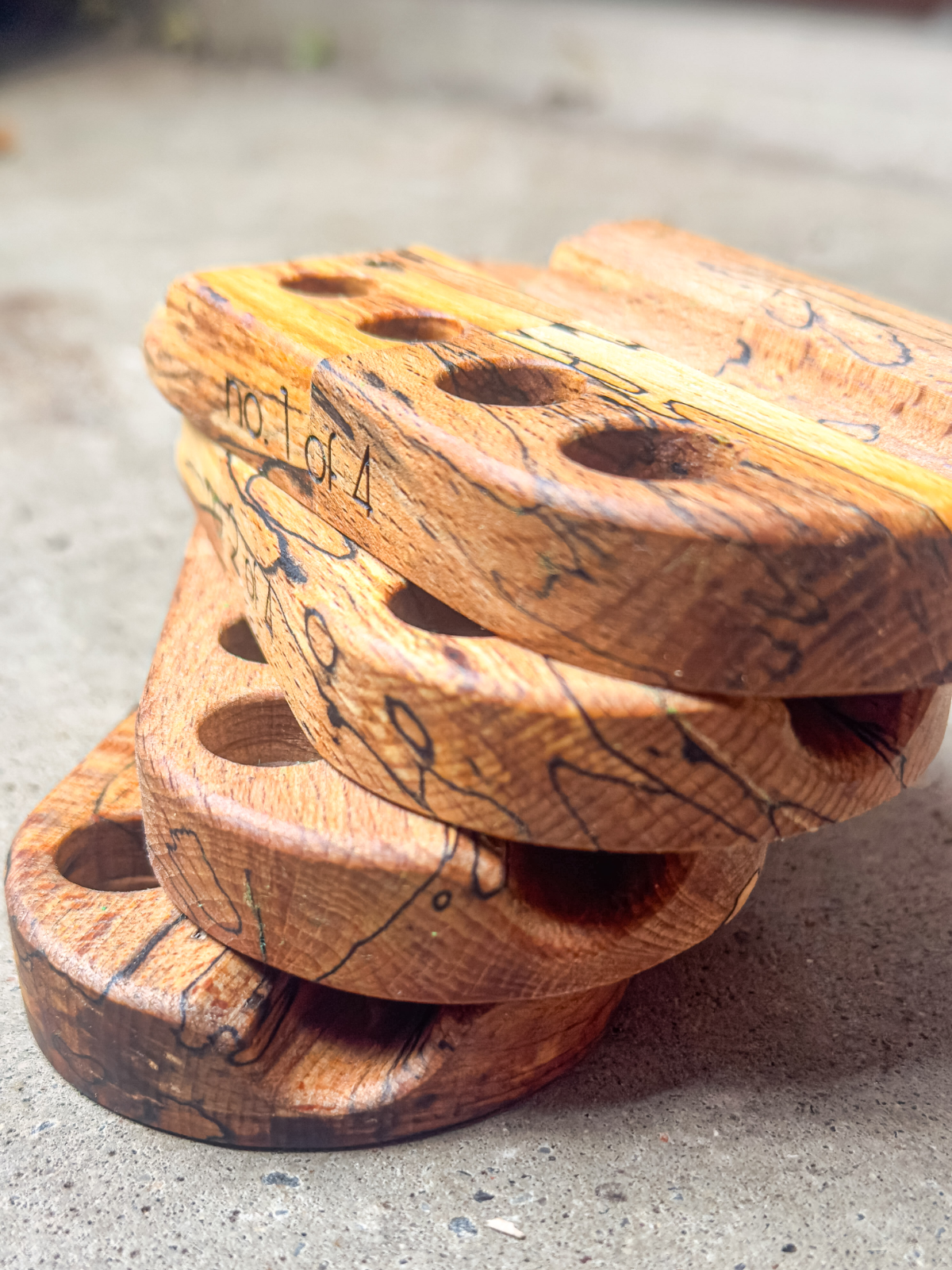 Stacked Doink Rolling Stations in spalted beech wood featuring black grain lines and hand-engraved numbering on the side.